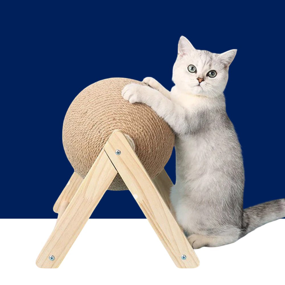 Sea Dragon Dreams cat scratching ball toy with natural sisal rope on a wooden stand, being used by a white kitten.