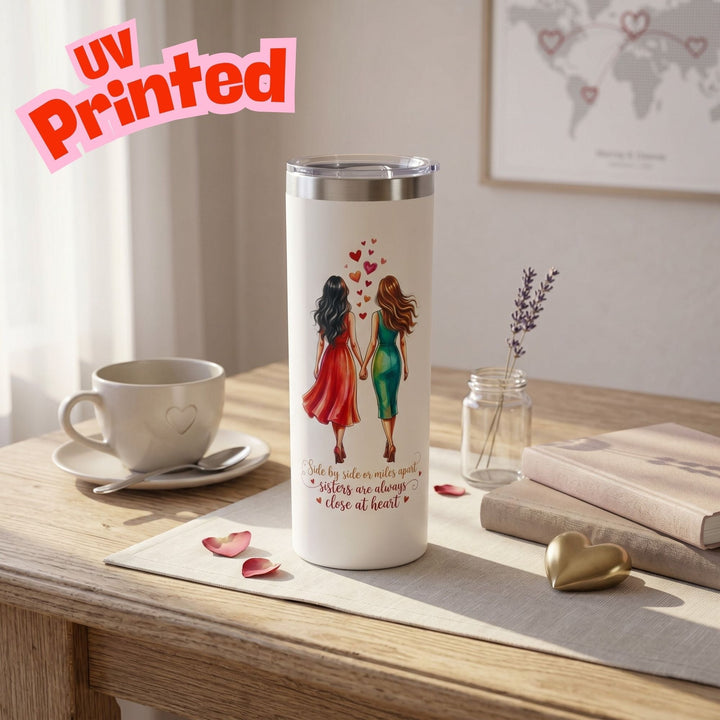 Sea Dragon Dreams 20oz white stainless steel skinny tumbler with UV printed illustration of two sisters holding hands