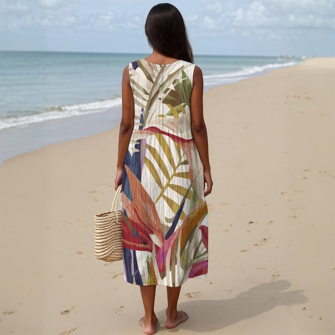 Sea Dragon Dreams sleeveless cotton slub dress with tropical leaf print worn by a woman on a sandy beach