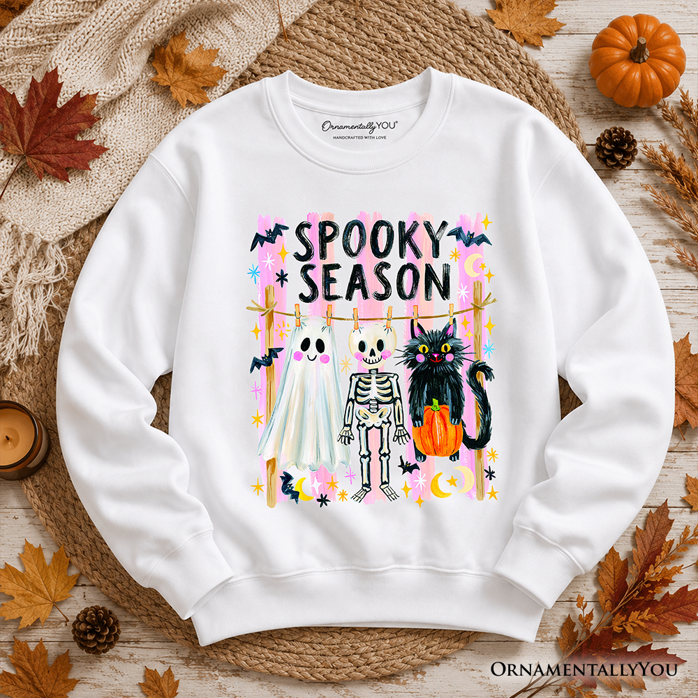 Sea Dragon Dreams white unisex sweatshirt featuring a colorful Spooky Season ghost, skeleton, and black cat graphic.