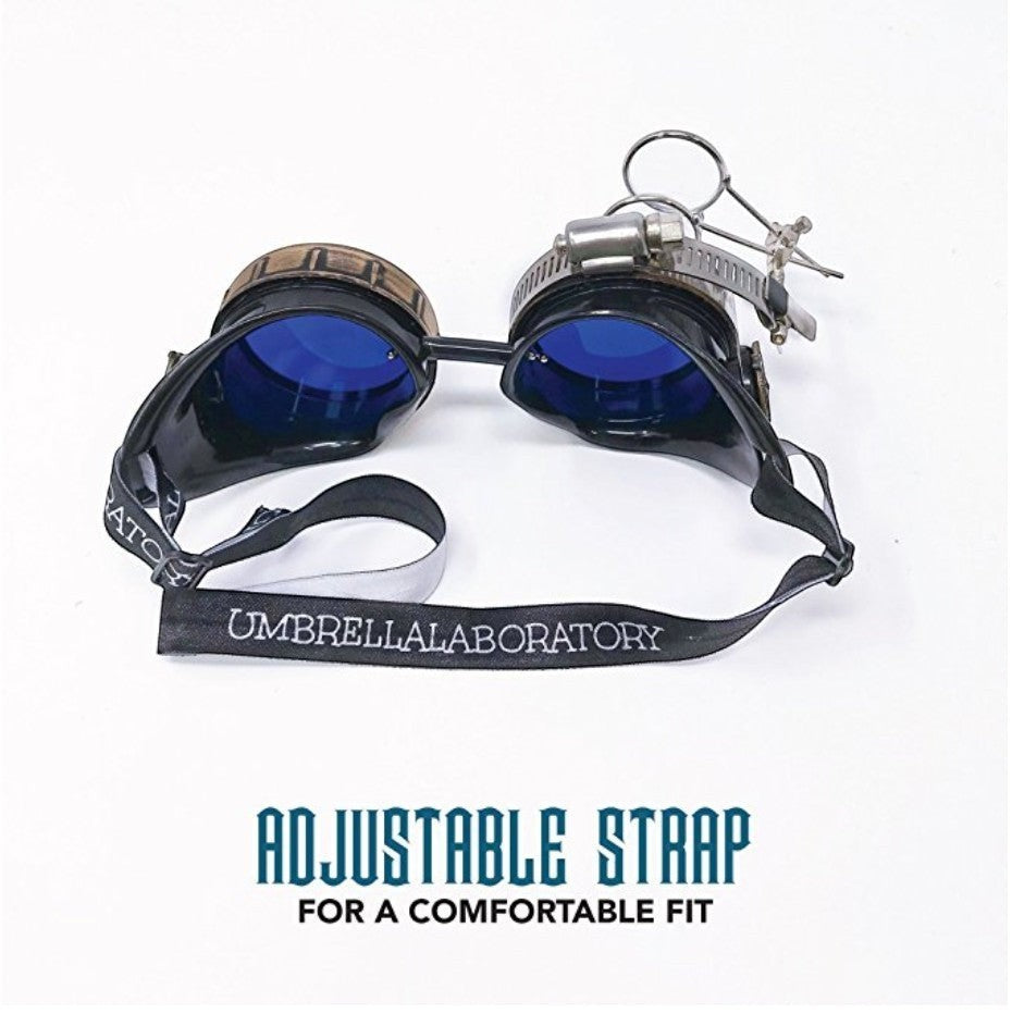 Sea Dragon Dreams handmade Victorian steampunk goggles with blue lenses, bronze-tone frame, and removable magnifying loupe.