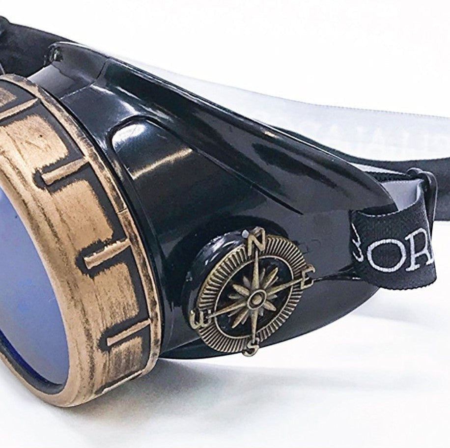 Sea Dragon Dreams handmade steampunk goggles with bronze-tone compass detail, black frame, and blue tinted lenses.