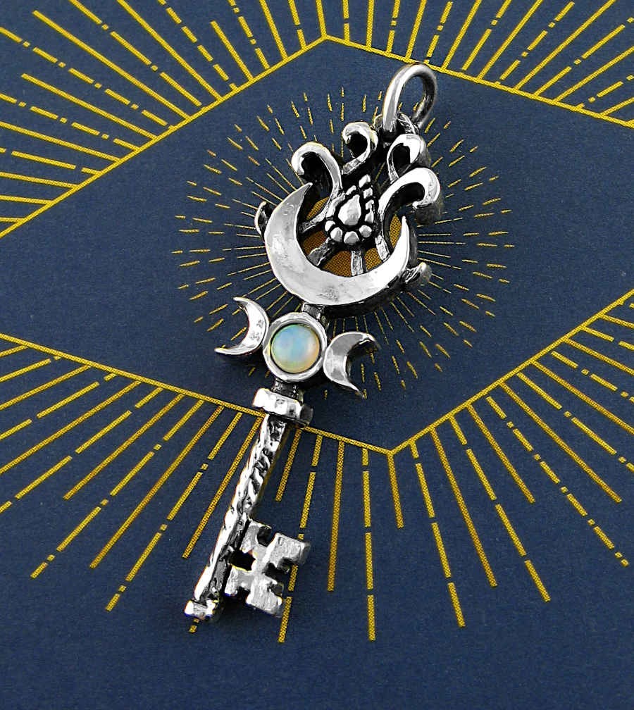 Sea Dragon Dreams sterling silver key pendant with a natural opal cabochon and Triple Moon celestial design.