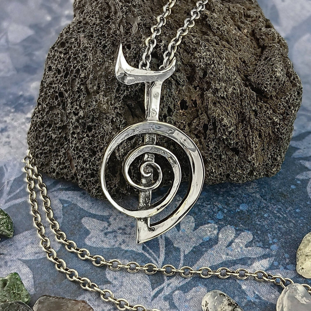 Sea Dragon Dreams handmade sterling silver Cho Ku Rei Reiki pendant with a sculptural spiral design on a lava rock.