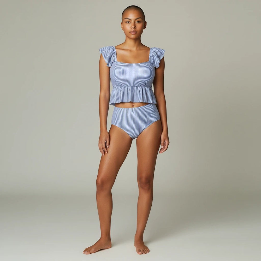 Sea Dragon Dreams women's blue and white striped bikini set with a peplum top and high-waisted bottoms on a model.