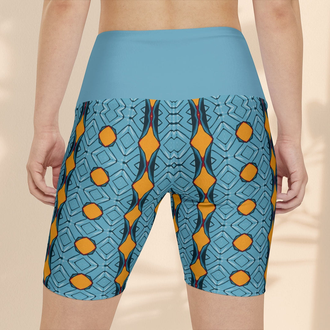Sea Dragon Dreams women's workout shorts with a blue and orange geometric pattern and high-waisted solid blue band.