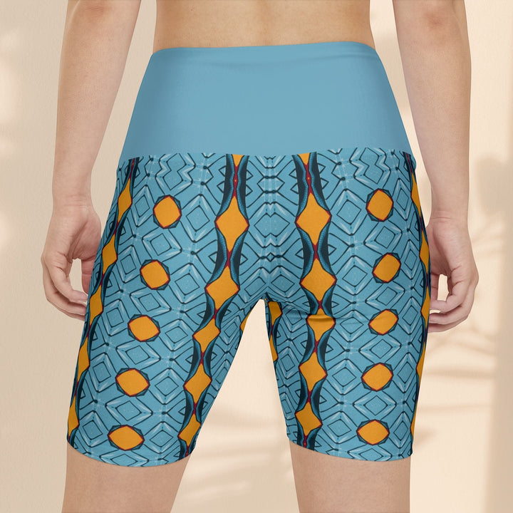 Sea Dragon Dreams women's workout shorts with a blue and orange geometric pattern and high-waisted solid blue band.