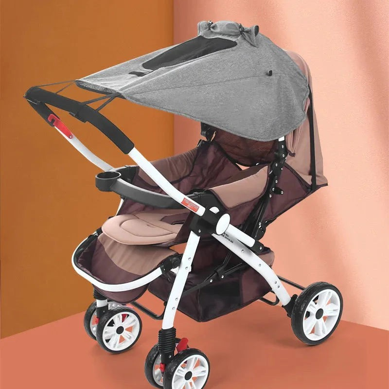 Sea Dragon Dreams universal grey stroller sun shade canopy attached to a brown and white baby pram for UV protection