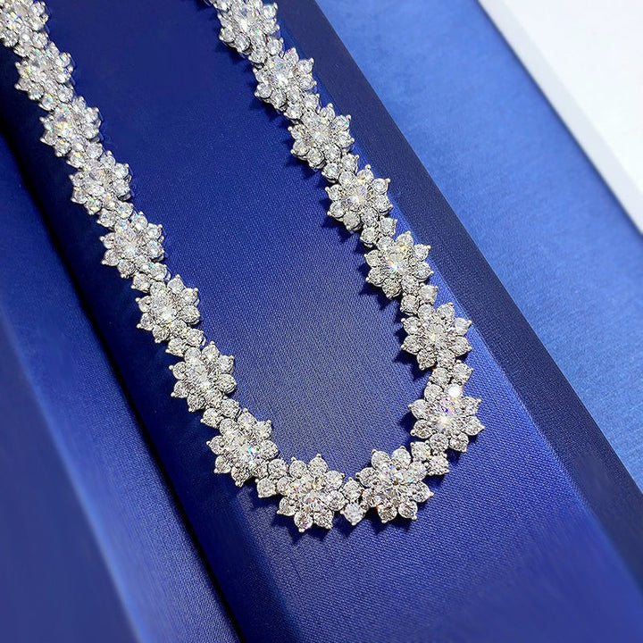 Sea Dragon Dreams sterling silver sunflower necklace featuring sparkling high-carbon diamond accents on a blue display