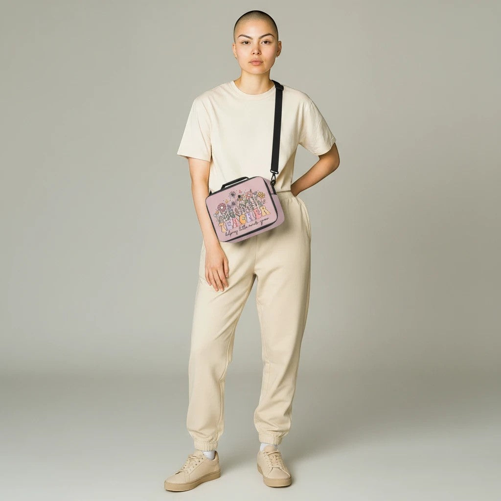Sea Dragon Dreams lunch bag with Teacher Helping Little Minds Grow print, worn as a crossbody by a model in beige.