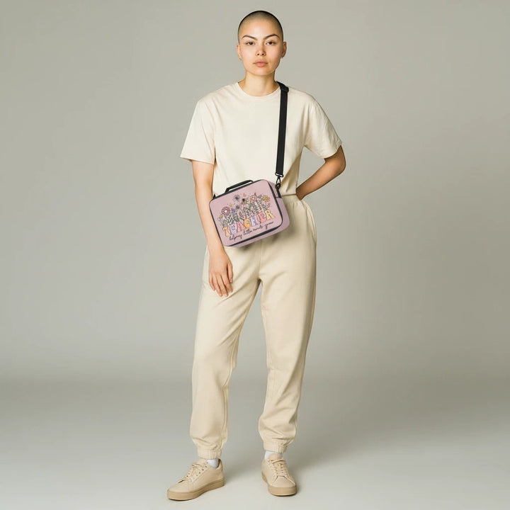 Sea Dragon Dreams lunch bag with Teacher Helping Little Minds Grow print, worn as a crossbody by a model in beige.