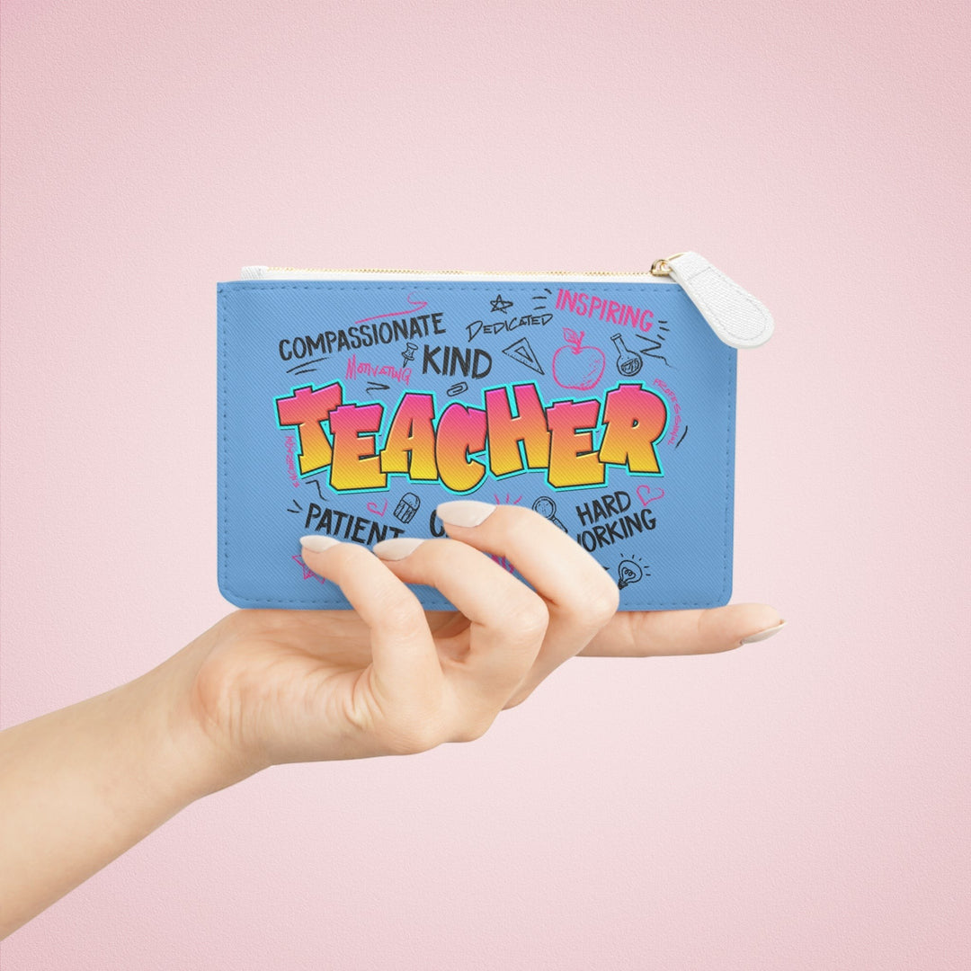 Sea Dragon Dreams teacher-themed mini clutch bag in blue vegan leather with a colourful graphic print and zip closure.