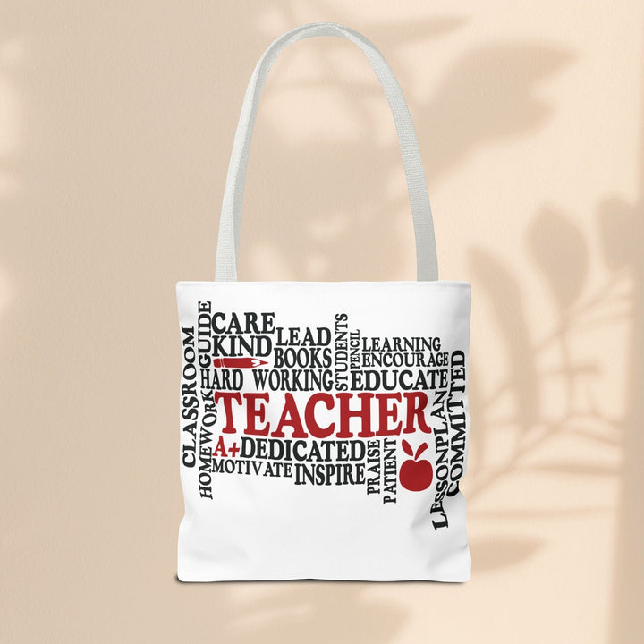 Sea Dragon Dreams What is a Teacher tote bag with black and red typography and apple icon on white polyester fabric.