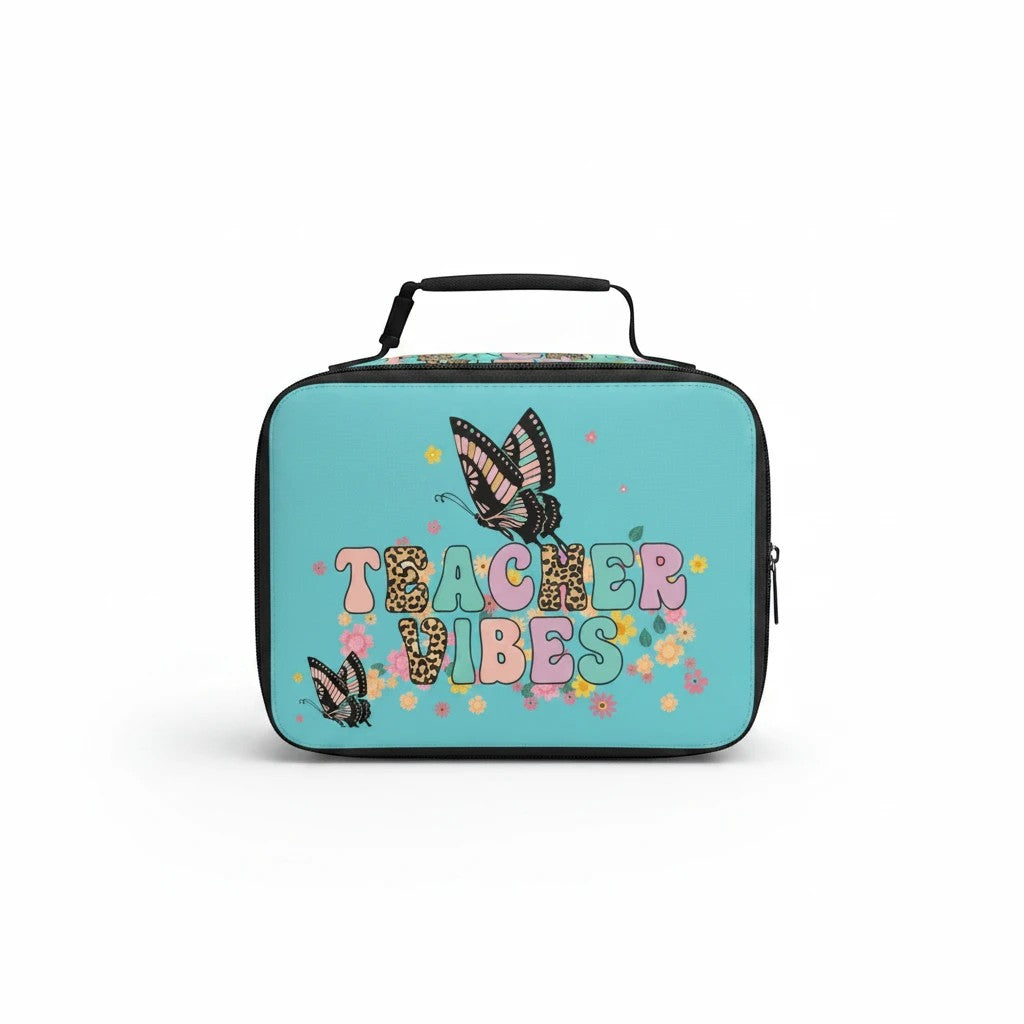 Sea Dragon Dreams Teacher Vibes lunch bag in light blue with butterfly and floral print and a black carrying handle.