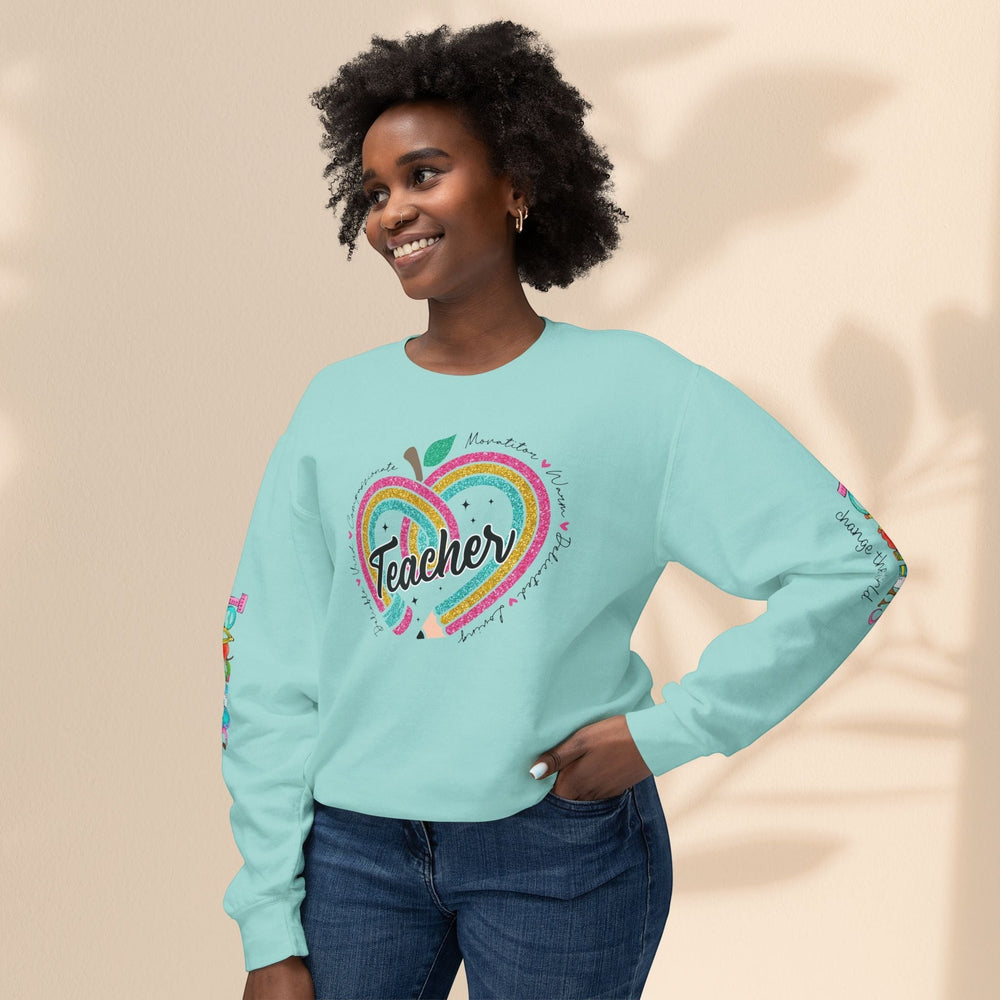 Sea Dragon Dreams light blue crewneck sweatshirt with Teachers Change The World heart graphic worn by a smiling woman