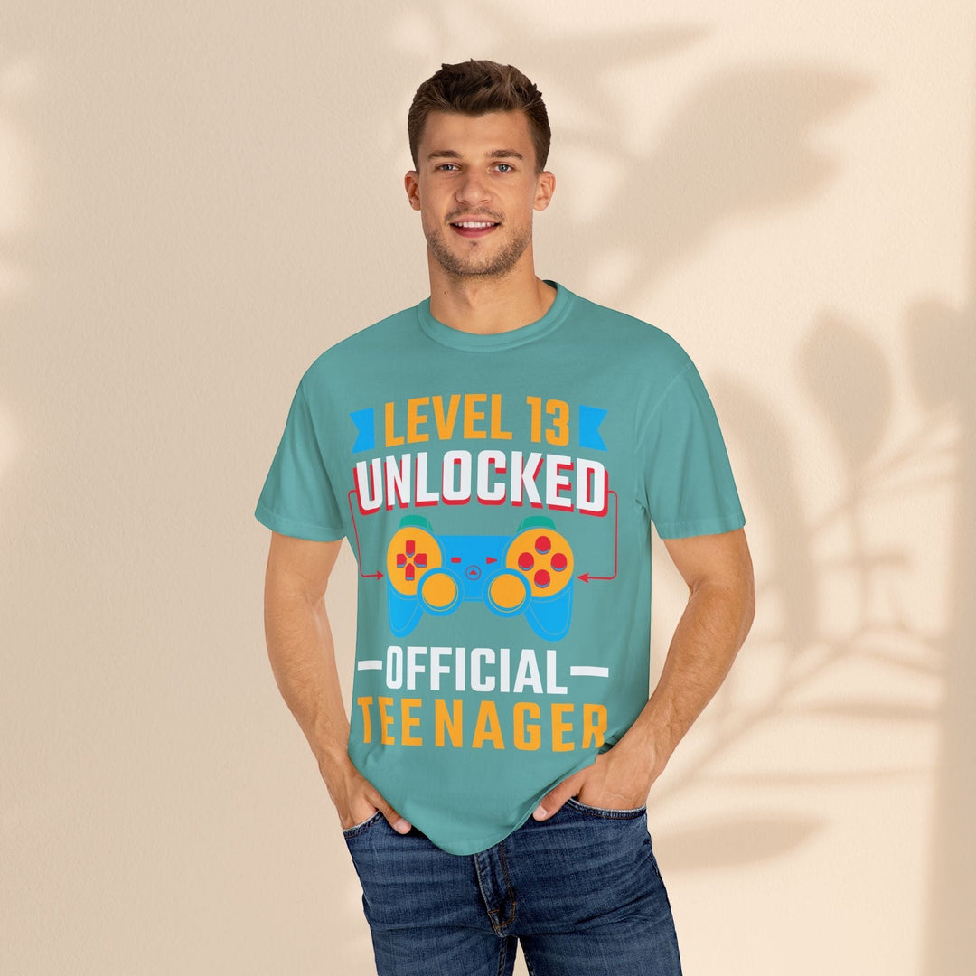 Sea Dragon Dreams unisex teal cotton t-shirt with Level 13 Unlocked Official Teenager gamer graphic on a male model.