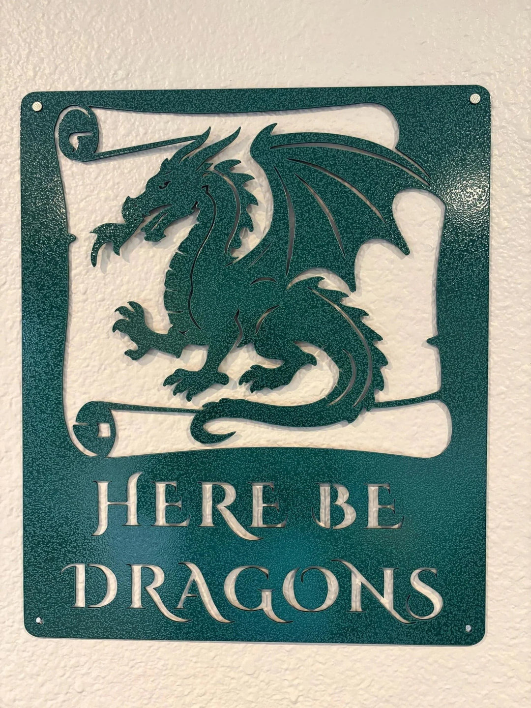 Sea Dragon Dreams Here Be Dragons metal wall sign in teal powder-coated steel with a detailed dragon silhouette.