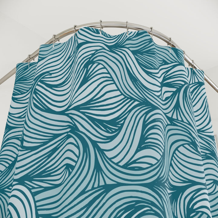 Sea Dragon Dreams teal and white wavy ocean pattern polyester shower curtain hanging on a curved rod