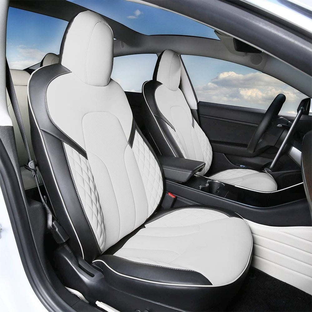 Sea Dragon Dreams white and black leather seat covers installed in a Tesla Model 3 Highland or Model Y interior