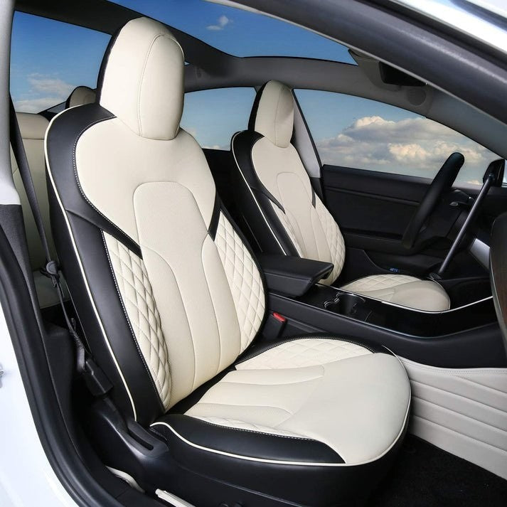 Sea Dragon Dreams custom white and black leather seat covers installed in a Tesla Model 3 or Model Y interior.