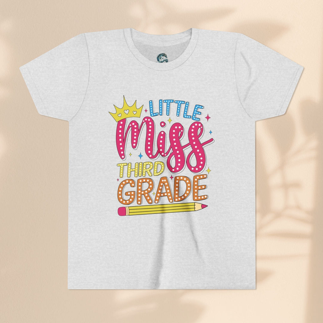Sea Dragon Dreams youth tee with Little Miss Third Grade graphic featuring a crown and pencil on soft white cotton.