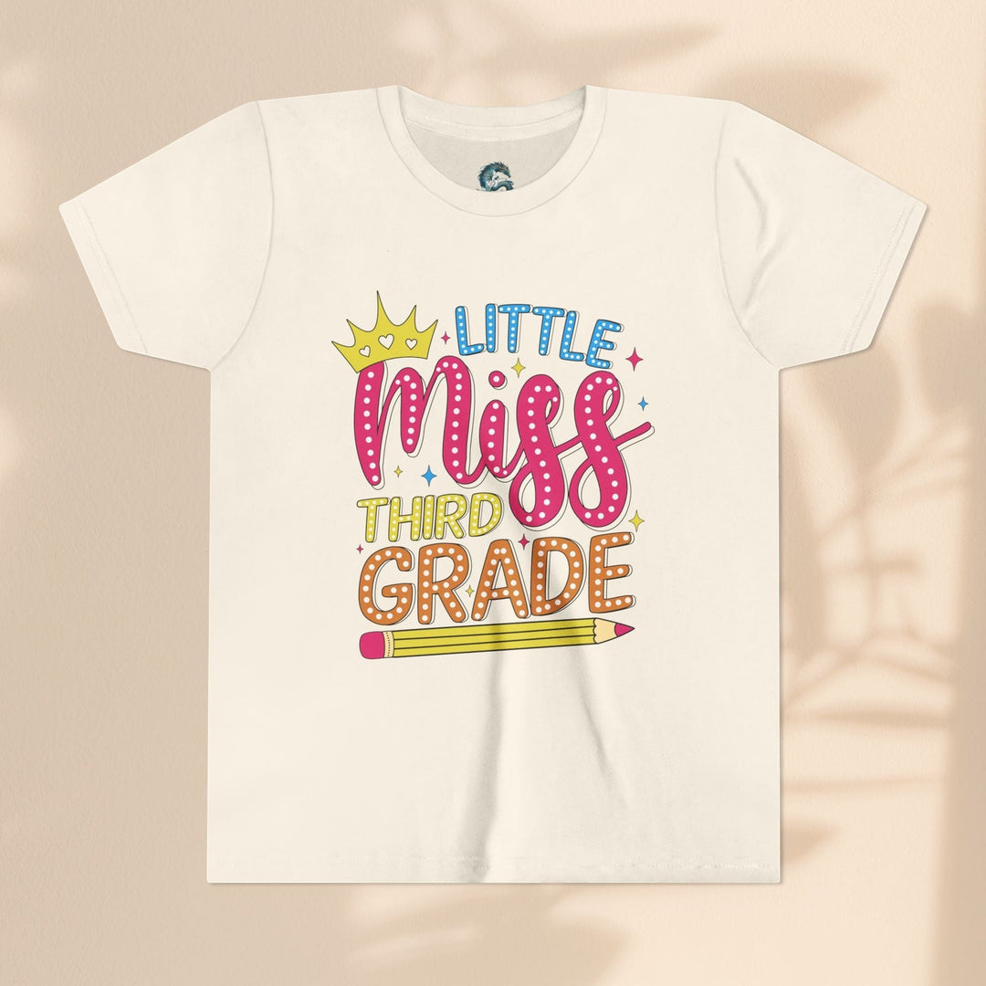 Sea Dragon Dreams youth t-shirt with Little Miss Third Grade graphic, crown, and pencil design on cream cotton.