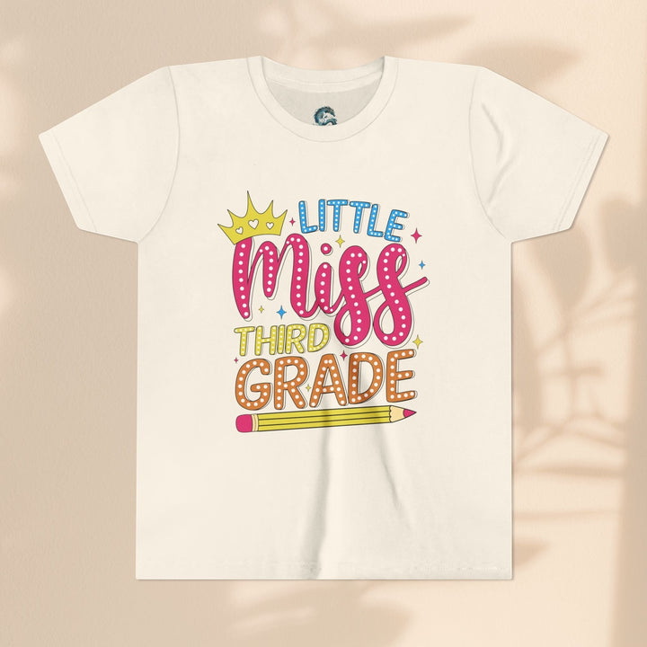 Sea Dragon Dreams youth t-shirt with Little Miss Third Grade graphic, crown, and pencil design on cream cotton.