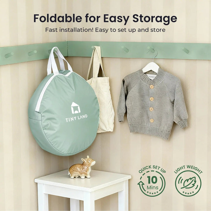 Sea Dragon Dreams Tiny Land 3-in-1 play tunnel in a sage green portable storage bag hanging on a wall hook.