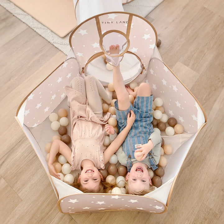 Sea Dragon Dreams Tiny Land 5-in-1 play tunnel with star pattern, featuring two children playing inside.