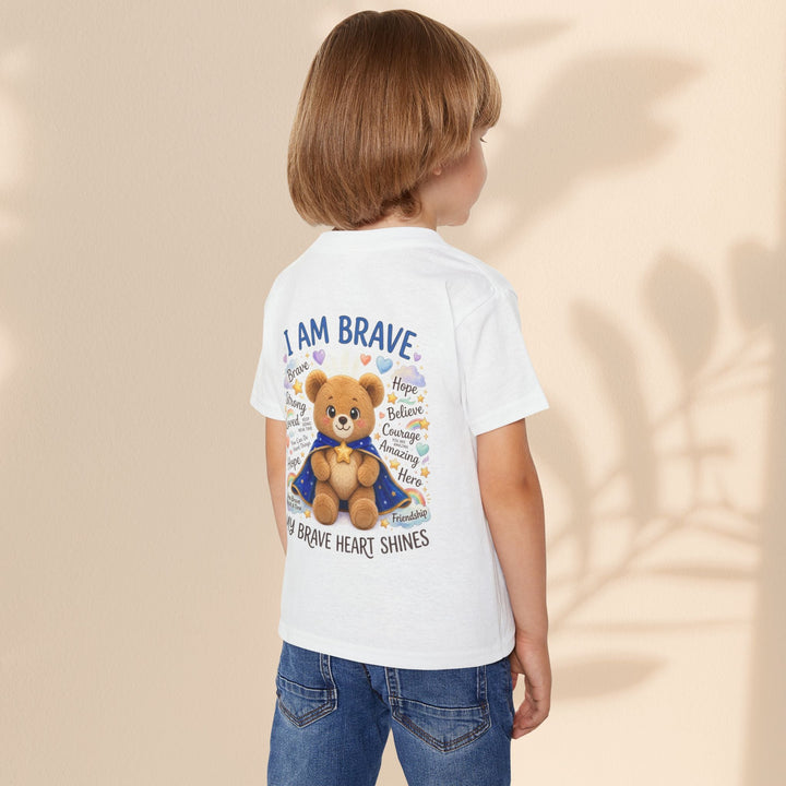 Sea Dragon Dreams toddler wearing a white cotton t-shirt with a teddy bear graphic and I Am Brave text on the back