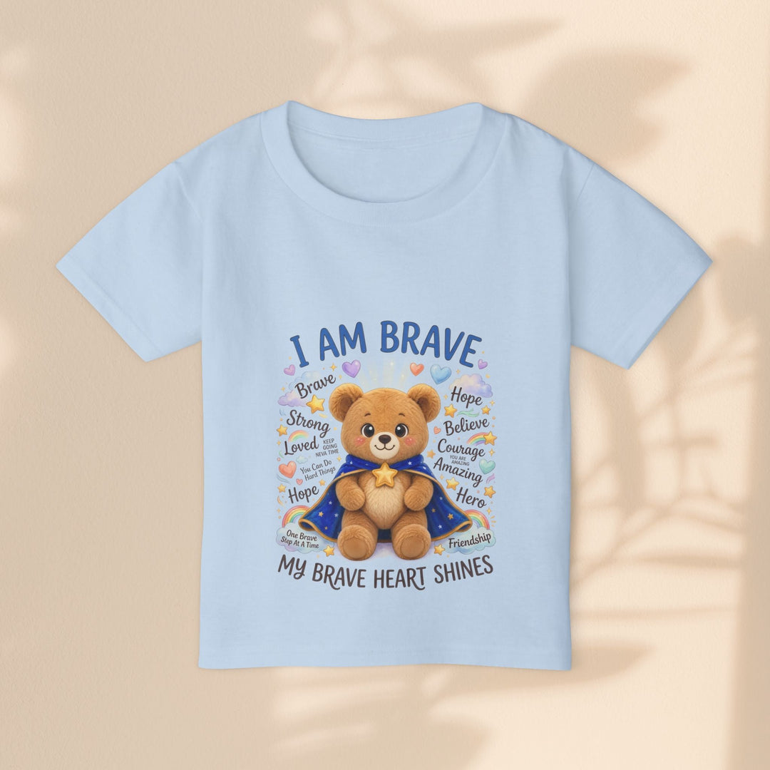 Sea Dragon Dreams light blue toddler t-shirt featuring a cute teddy bear in a cape with the text I Am Brave