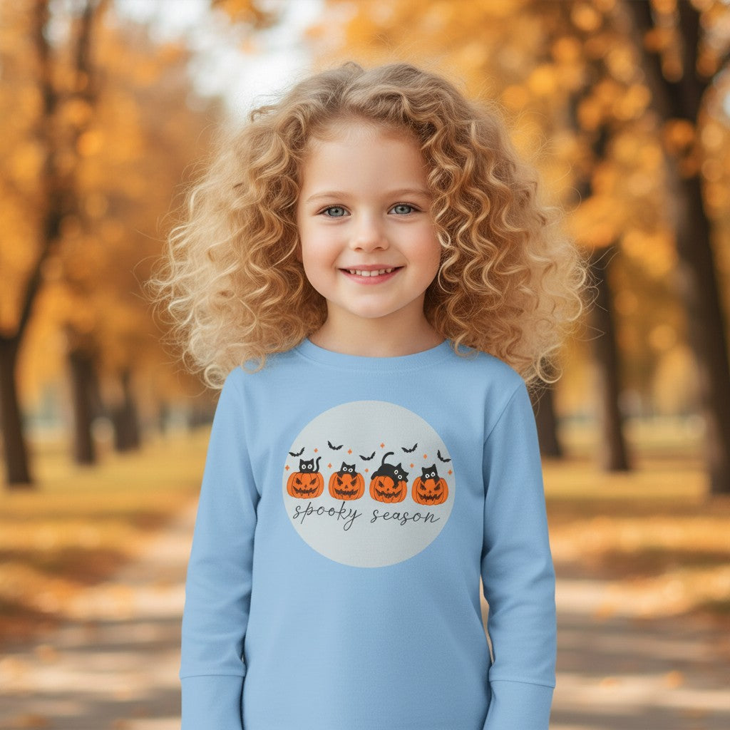 Sea Dragon Dreams toddler wearing a light blue long sleeve Halloween tee with a pumpkin and cat Spooky Season print
