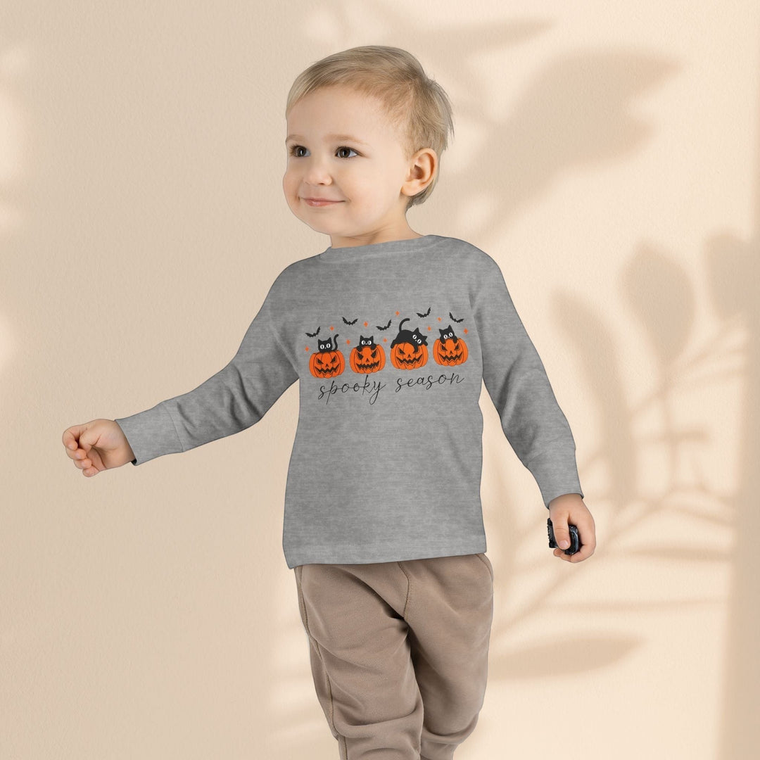 Toddler wearing a Sea Dragon Dreams grey long sleeve Halloween tee with a pumpkin and black cat print
