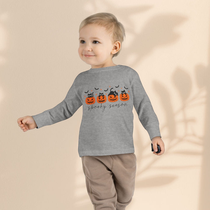 Toddler wearing a Sea Dragon Dreams grey long sleeve Halloween tee with a pumpkin and black cat print