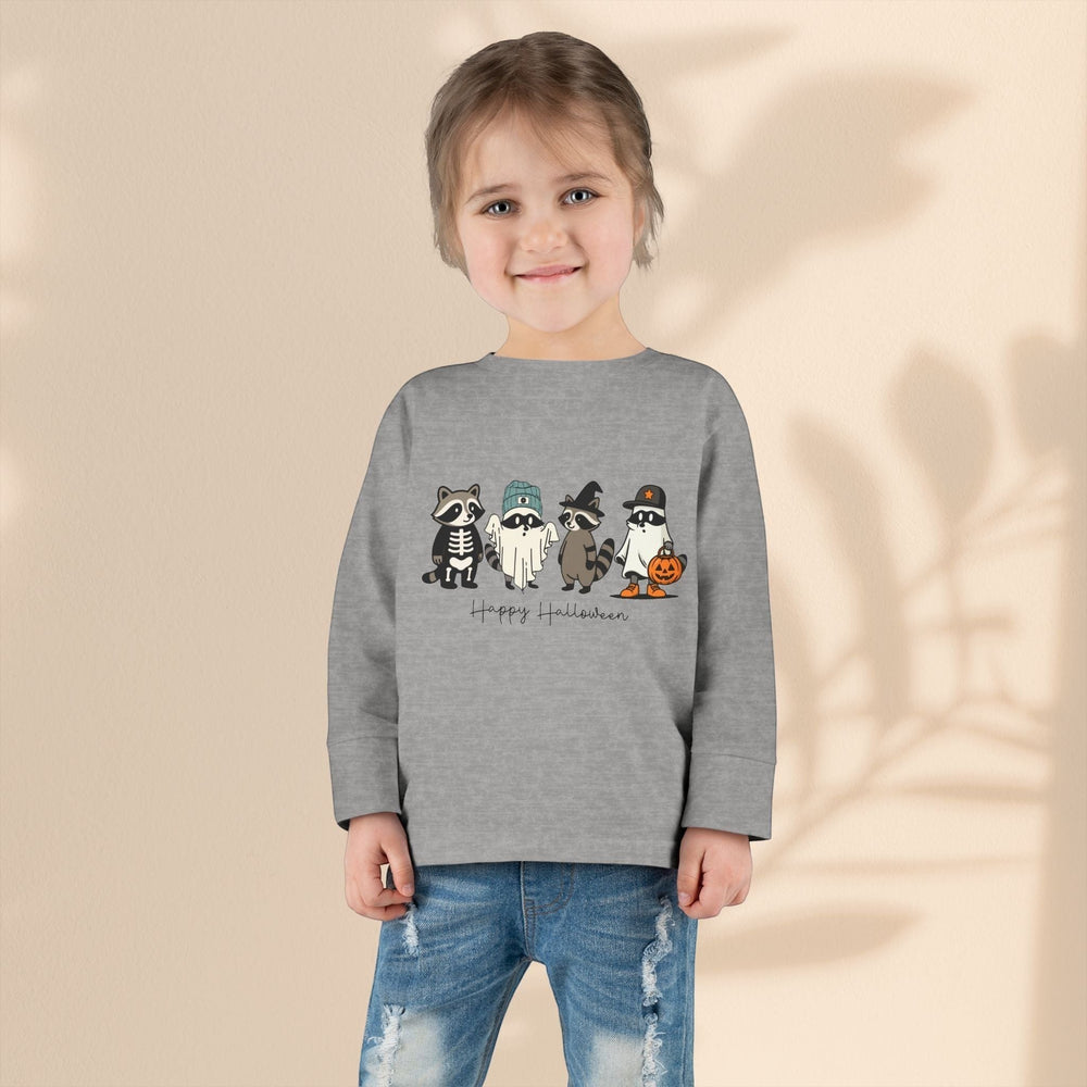 A young child wears a Sea Dragon Dreams grey long-sleeve toddler Halloween tee featuring cute ghost raccoons.