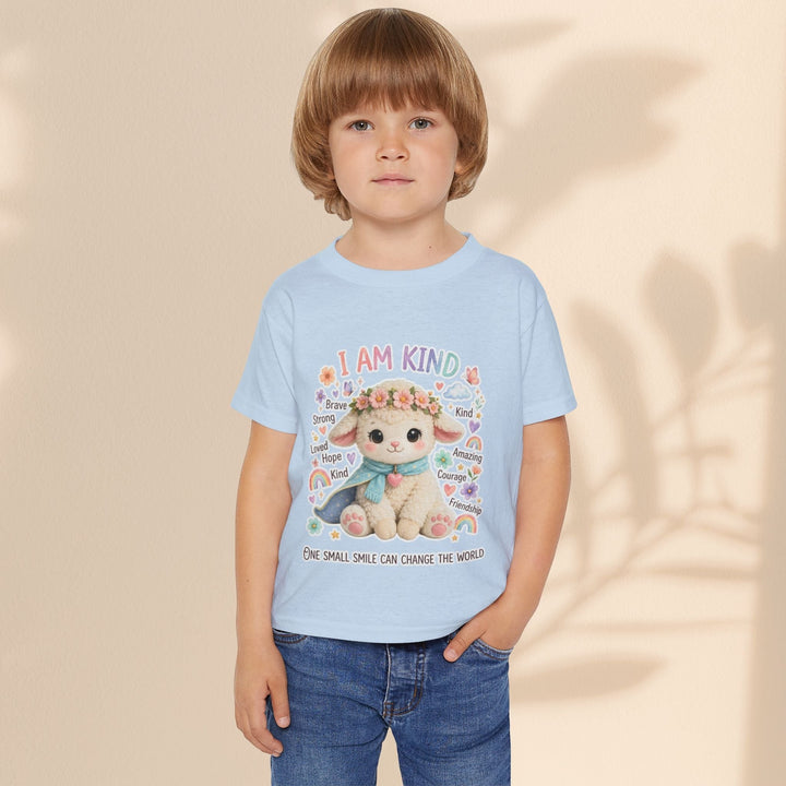 Sea Dragon Dreams toddler wearing a light blue cotton t-shirt with a Grace Lamb illustration and I Am Kind text.