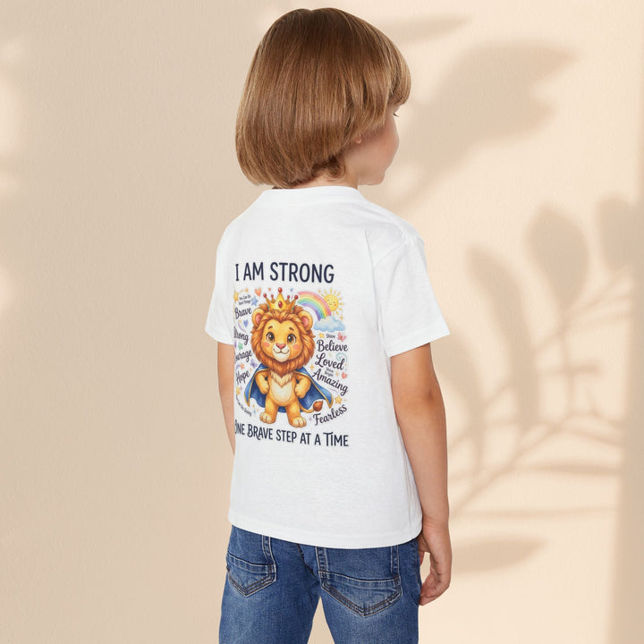 Sea Dragon Dreams toddler t-shirt with I Am Strong lion graphic on back, worn by a child in jeans.