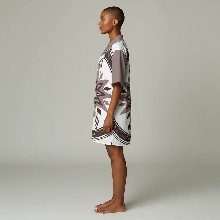 A model wearing a Sea Dragon Dreams unisex Hawaiian shirt with a brown and white tribal pattern and Cuban collar.