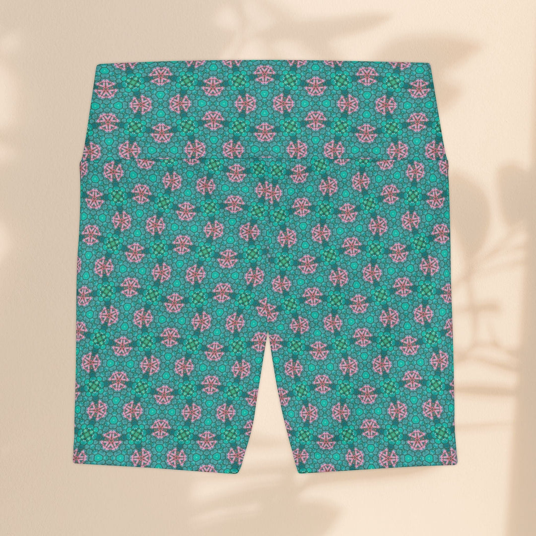 Sea Dragon Dreams women's workout shorts featuring a vibrant teal and pink tropical geometric pattern.