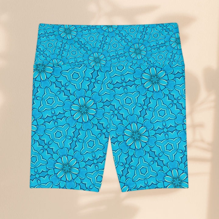 Sea Dragon Dreams turquoise workout shorts with a groovy floral pattern, made from lightweight, quick-dry polyester.