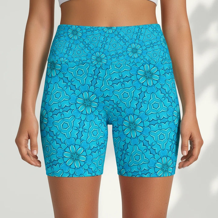 Sea Dragon Dreams turquoise workout shorts with a groovy floral pattern, made from lightweight, quick-drying polyester.