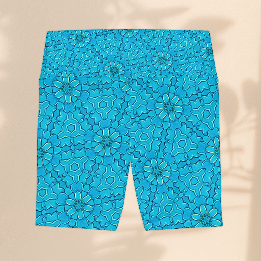 Sea Dragon Dreams turquoise workout shorts with a groovy floral pattern, made from lightweight polyester fabric.