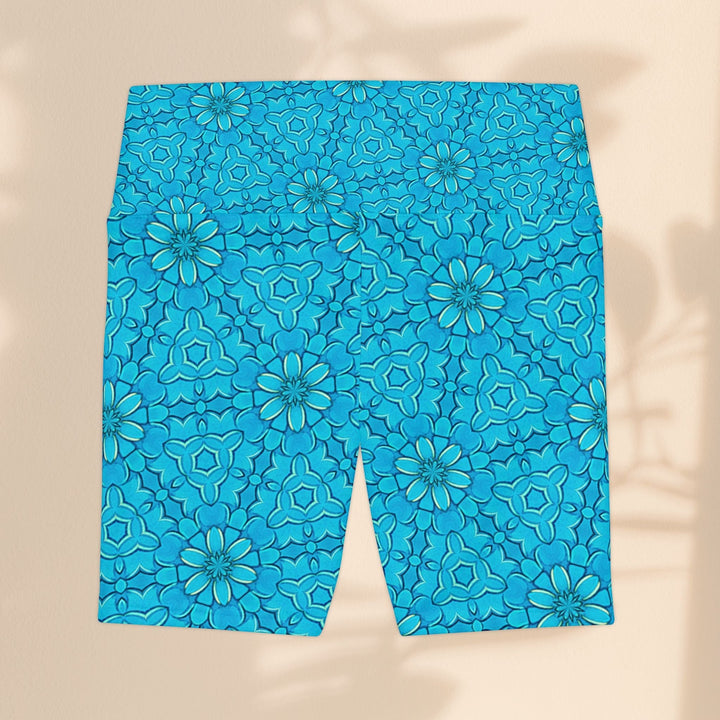 Sea Dragon Dreams turquoise workout shorts with a groovy floral pattern, made from lightweight polyester fabric.