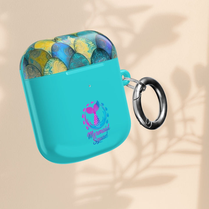 Sea Dragon Dreams turquoise AirPods case featuring a mermaid tail pattern and Mermaid Squad logo with a metal carabiner.