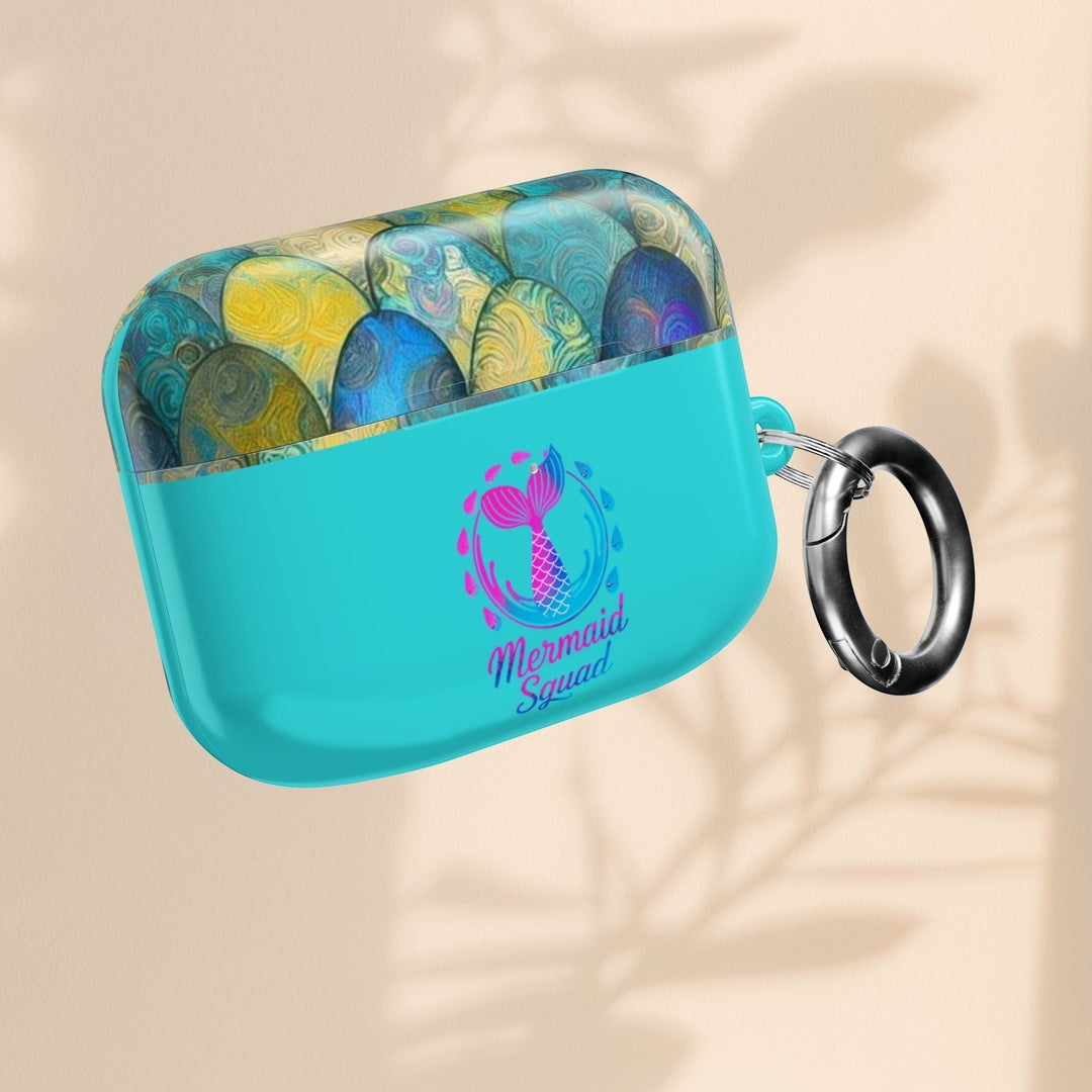 Sea Dragon Dreams turquoise AirPods case with mermaid tail artwork and a black carabiner clip.