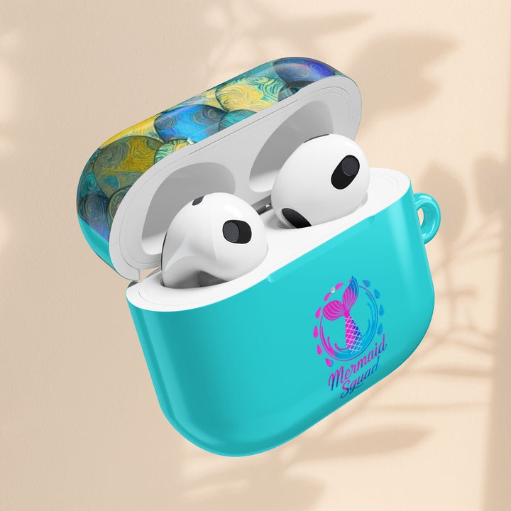 Sea Dragon Dreams turquoise AirPods case with Mermaid Squad tail artwork and patterned lid, open with earbuds inside.