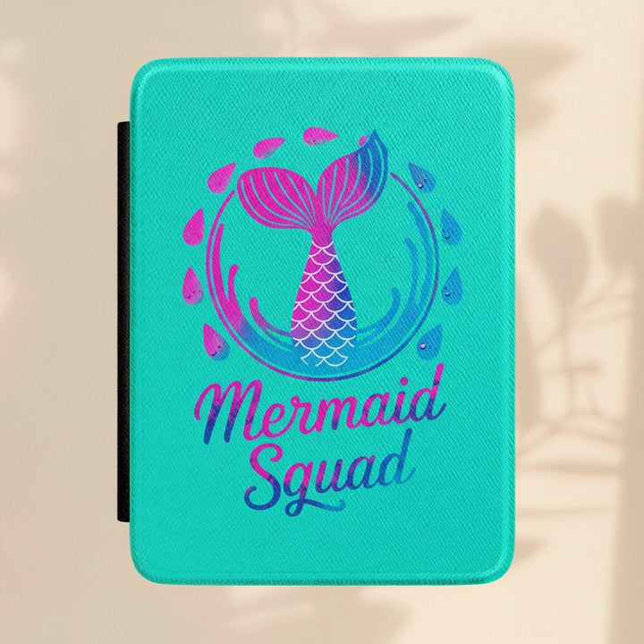 Sea Dragon Dreams turquoise Kindle case with a mermaid tail graphic and Mermaid Squad text in a shimmering design.