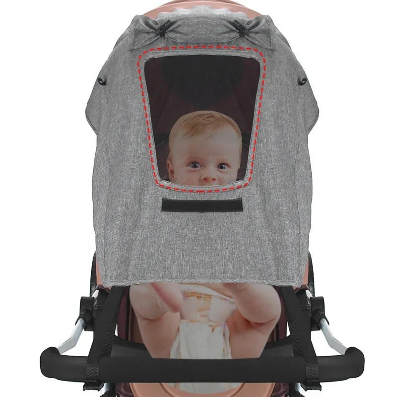 Sea Dragon Dreams universal grey stroller sun shade with a mesh viewing window protecting a baby in a pram