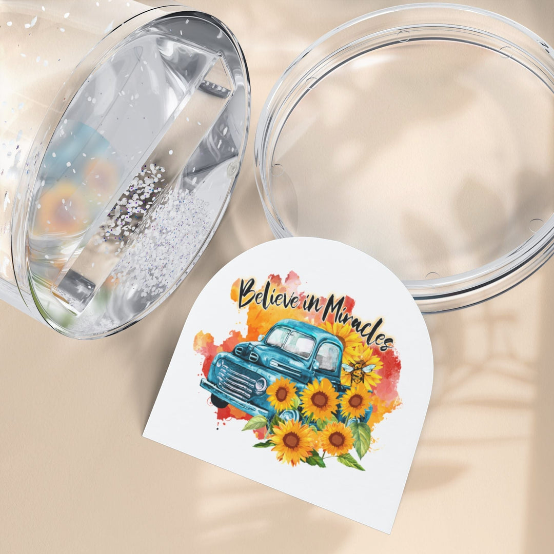 Sea Dragon Dreams Believe in Miracles snow globe insert featuring a vintage blue truck and sunflowers on a beige surface