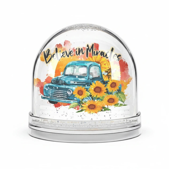Sea Dragon Dreams Believe in Miracles snow globe featuring a vintage blue truck and sunflowers in a plastic dome.